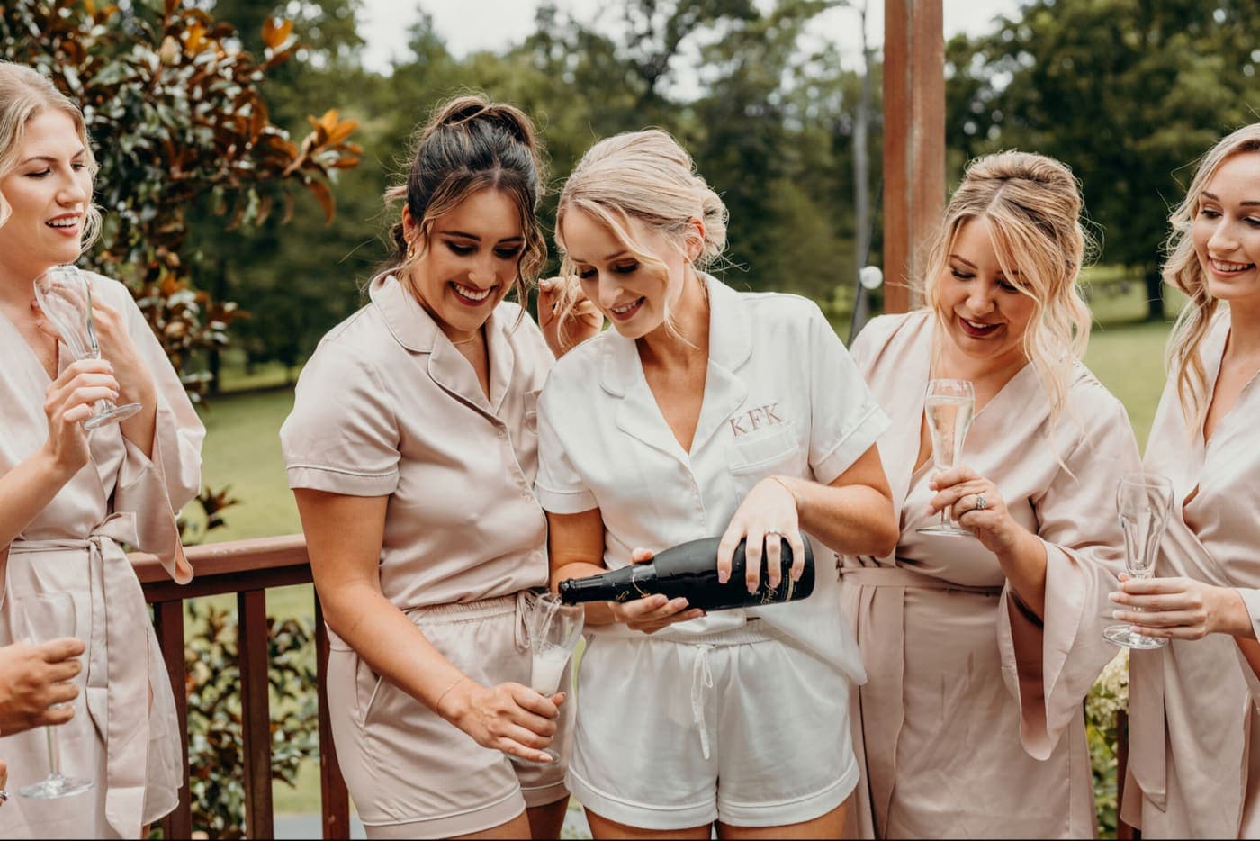 The wedding party celebrating together with champagne.